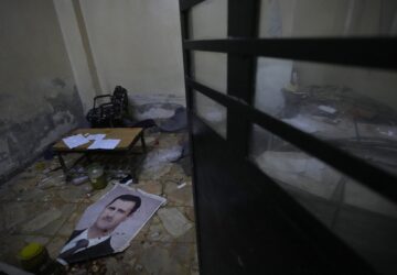 A portrait of ousted Syrian president Bashar Assad lies on the ground at Branch 215, a detention facility run by military intelligence during Bashar Assad's regime in Damascus, Syria, on Dec. 17, 2024. (AP Photo/Hussein Malla)