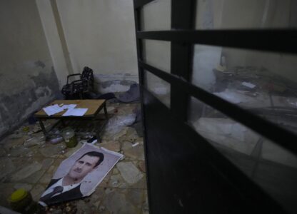 A portrait of ousted Syrian president Bashar Assad lies on the ground at Branch 215, a detention facility run by military intelligence during Bashar Assad's regime in Damascus, Syria, on Dec. 17, 2024. (AP Photo/Hussein Malla)