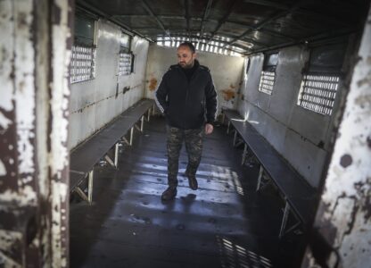 Mahmoud Abdulbaki stands in one of the trucks used during the time he was in the Military Police prison in Damascus, Syria, on Dec. 15, 2024. (AP Photo/Ghaith Alsayed)