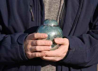 Eric Pranger holds an Urn that contains the ashes of Allen Livingston, Saturday, Dec. 21, 2024, in Westfield, Ind. (AP Photo/Darron Cummings)