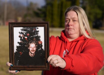 Shannon Doughty holds a photo of her late brother Allen Livingston, who was identified in October 2023 as the ninth known victim of suspected serial killer Herbert Baumeister, Saturday, Dec. 21, 2024, in Westfield, Ind. (AP Photo/Darron Cummings)