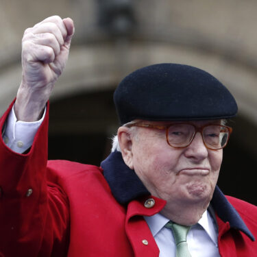 FILE - Former far-right National Front party leader Jean-Marie Le Pen clenches his fist at the statue of Joan of Arc, Monday May 1, 2017, in Paris. (AP Photo/Kamil Zihnioglu, File)