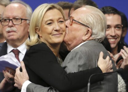 FILE - French far-right Front National leader Marine Le Pen is kissed by her father Jean-Marie Le Pen, in Lyon, central France, Sunday Nov. 30, 2014. (AP Photo/Laurent Cipriani, File)