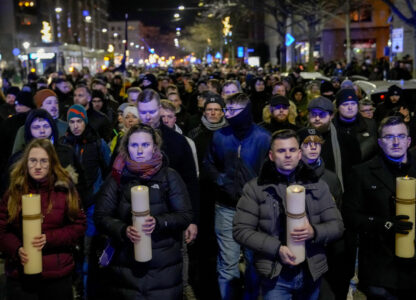 FILE - People carry candles attending an AfD election campaign in front of the cathedral in Magdeburg, Germany, on Dec. 23, 2024. (AP Photo/Ebrahim Noroozi, File)