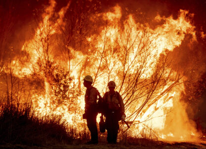 Fire crews battle the Kenneth Fire in the West Hills section of Los Angeles, Thursday, Jan. 9, 2025. (AP Photo/Ethan Swope)