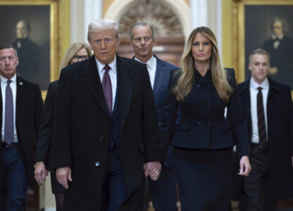 President-elect Donald Trump walks with Melania Trump at the Capitol, Wednesday, Jan. 8, 2025, in Washington, followed by Senate Majority Leader John Thune, R-S.D. (AP Photo/Jose Luis Magana)