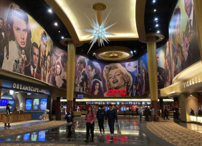 FILE - People walk in an AMC Theater in Paramus, New Jersey, on Monday, March 13, 2023. (AP Photo/Ted Shaffrey, File)