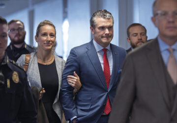 FILE - Pete Hegseth, President-elect Donald Trump's nominee to be defense secretary, right, joined by his wife Jennifer Rauchet, arrives at the Capitol in Washington, Dec. 5, 2024. (AP Photo/J. Scott Applewhite, File)