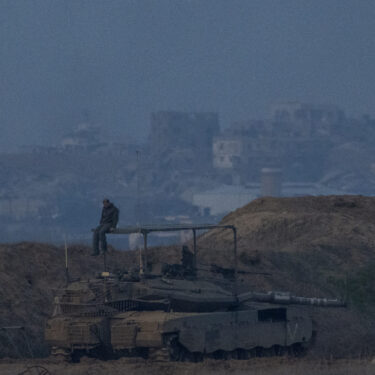 An Israeli soldier sits on a tank at the border with Gaza in southern Israel on Thursday, Jan. 16, 2025. (AP Photo/Ariel Schalit)