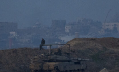 An Israeli soldier sits on a tank at the border with Gaza in southern Israel on Thursday, Jan. 16, 2025. (AP Photo/Ariel Schalit)