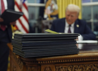 President Donald Trump signs executive orders in the Oval Office of the White House, Monday, Jan. 20, 2025, in Washington. (AP Photo/Evan Vucci)