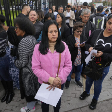 Gloria Camacho holds a notification stating her visa appointment was canceled, due to Colombian President Gustavo Petro's refusal to accept repatriation flights of Colombian citizens from the U.S., outside the U.S. embassy in Bogota, Colombia, Monday, Jan. 27, 2025. (AP Photo/Fernando Vergara)