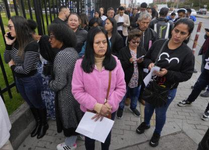 Gloria Camacho holds a notification stating her visa appointment was canceled, due to Colombian President Gustavo Petro's refusal to accept repatriation flights of Colombian citizens from the U.S., outside the U.S. embassy in Bogota, Colombia, Monday, Jan. 27, 2025. (AP Photo/Fernando Vergara)
