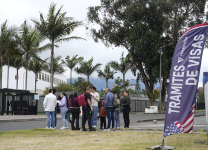 People stand outside the U.S. embassy in Bogota, Colombia, where visa applicants were notified that appointments were canceled due to Colombian President Gustavo Petro's refusal to accept repatriation flights of Colombian citizens from the United States, Monday, Jan. 27, 2025. (AP Photo/Fernando Vergara)
