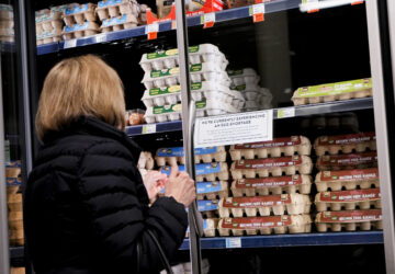 A shopper browses for eggs in front of a sign posted about egg shortages at a PCC Community Markets grocery store Monday, Jan. 27, 2025, in Seattle. (AP Photo/Lindsey Wasson)