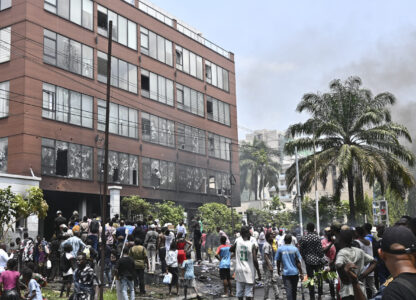 People attack the Rwanda Embassy in Kinshasa, Democratic Republic of the Congo Tuesday, Jan. 28, 2025, in protest over the Rwanda-backed M23 rebels' advances into eastern Congo's capital Goma.(AP Photo/Samy Ntumba Shambuyi)