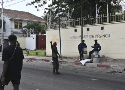 Congolese security personnel stand in front of the French Embassy in Kinshasa, Democratic Republic of the Congo Tuesday, Jan. 28, 2025, after it was attacked by demonstrators protesting the Rwanda-backed M23 rebels' advances into eastern Congo's capital Goma. (AP Photo/Samy Ntumba Shambuyi)