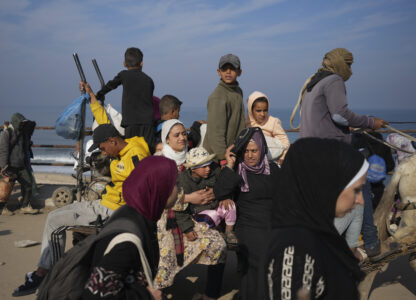 Displaced Palestinians ride in a horse-drawn cart as they return to their homes in the northern Gaza Strip, Tuesday, Jan. 28, 2025, after Israel's decision to allow thousands of them to go back for the first time since the early weeks of the 15-month war with Hamas. (AP Photo/Abdel Kareem Hana)