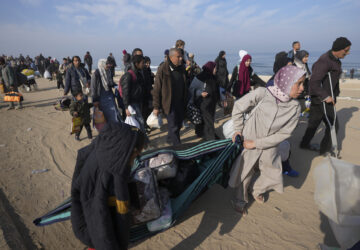 Carrying their belongings displaced Palestinians walk on a road to return to their homes in the northern Gaza Strip, Tuesday, Jan. 28, 2025, after Israel's decision to allow thousands of them to go back for the first time since the early weeks of the 15-month war with Hamas. (AP Photo/Abdel Kareem Hana)