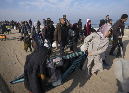 Carrying their belongings displaced Palestinians walk on a road to return to their homes in the northern Gaza Strip, Tuesday, Jan. 28, 2025, after Israel's decision to allow thousands of them to go back for the first time since the early weeks of the 15-month war with Hamas. (AP Photo/Abdel Kareem Hana)