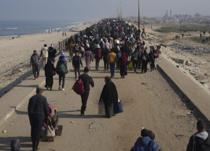 Displaced Palestinians walk on a road to return to their homes in the northern Gaza Strip, Tuesday, Jan. 28, 2025, after Israel's decision to allow thousands of them to go back for the first time since the early weeks of the 15-month war with Hamas. (AP Photo/Abdel Kareem Hana)