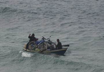 Displaced Palestinians ride on a boat in the Mediterranean Sea as they return to their homes in the northern Gaza Strip, Tuesday, Jan. 28, 2025. (AP Photo/Abdel Kareem Hana)