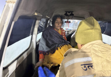A woman injured in a stampede is helped into an ambulance by the banks of the Sangam, the confluence of the Ganges, the Yamuna and the mythical Saraswati rivers, on Mauni Amavasya' or new moon day during the Maha Kumbh festival, in Prayagraj, Uttar Pradesh, India, Wednesday, Jan. 29, 2025. (AP Photo/Rajesh Kumar Singh)