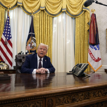 FILE - President Donald Trump answers questions from reporters as he signs an executive orders in the Oval Office of the White House, Jan. 23, 2025, in Washington. (AP Photo/Ben Curtis, File)
