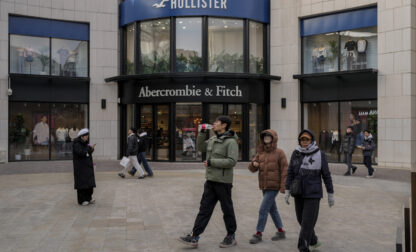 Chinese shoppers tour past American fashion boutiques at an outdoor shopping mall in Beijing, Tuesday, Feb. 4, 2025. (AP Photo/Andy Wong)