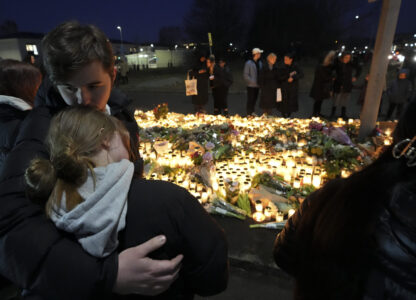 People take part in a vigil near the scene of a shooting at an adult education center on the outskirts of Orebro, Sweden, Thursday, Feb. 6, 2025. (AP Photo/Sergei Grits)