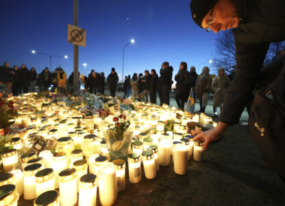 People take part in a vigil near the scene of a shooting at an adult education center on the outskirts of Orebro, Sweden, Thursday, Feb. 6, 2025. (AP Photo/Sergei Grits)