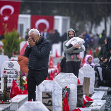 FILE - People visit graves in a cemetery where some of the victims of the earthquake in Feb. 2023 are buried in Antakya, southern Turkey, Tuesday, Feb. 6, 2024. (AP Photo/Metin Yoksu, File)