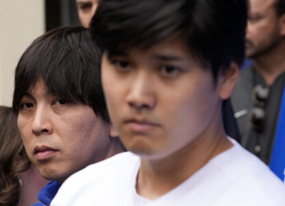 FILE - Interpreter Ippei Mizuhara, left, stands next to Los Angeles Dodgers player Shohei Ohtani, right, during an interview at Dodger Stadium, Feb. 3, 2024. (AP Photo/Richard Vogel, File)