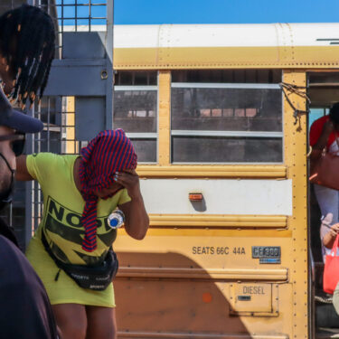 Haitians deported from the Dominican Republic get out of trucks in Carrizal, Dominican Republic, on the border with Haiti, Thursday, Jan. 30, 2025. (AP Photo/Martin Adames)