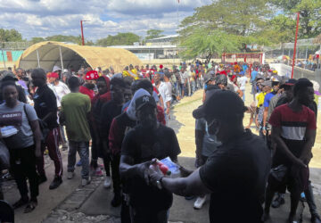 Haitians line up at a non-profit help center to receive food after being deported from the Dominican Republic, in Belladere, Haiti, Thursday, Jan. 30, 2025. (AP Photo/Danica Coto)