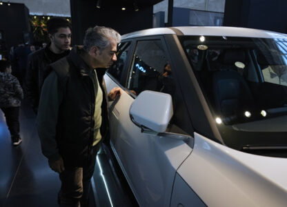 Visitors look at a car on display at the 6th International Tehran Auto Show and related industries, just outside Tehran, Iran, Thursday, Jan. 30, 2025. (AP Photo/Vahid Salemi)