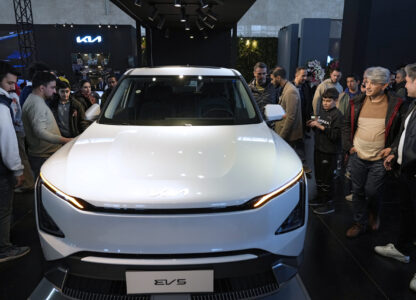 Visitors gather around a car on display at the 6th International Tehran Auto Show and related industries, just outside Tehran, Iran, Thursday, Jan. 30, 2025. (AP Photo/Vahid Salemi)