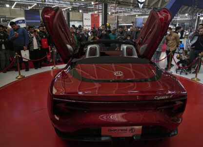 Visitors gather around a car on display at the 6th International Tehran Auto Show and related industries, just outside Tehran, Iran, Thursday, Jan. 30, 2025. (AP Photo/Vahid Salemi)