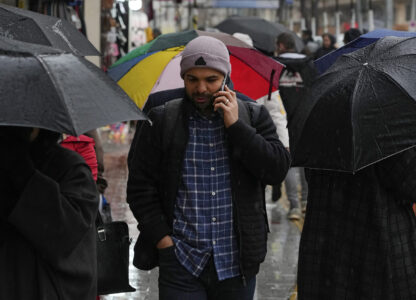 A man speaks on his cellphone while walking on a sidewalk in northern Tehran, Iran, Monday, Jan. 27, 2025. (AP Photo/Vahid Salemi)