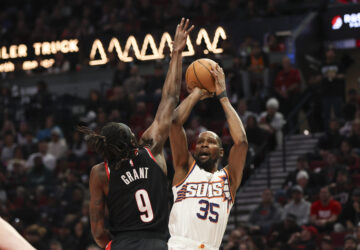 Phoenix Suns forward Kevin Durant (35) shoots over Portland Trail Blazers forward Jerami Grant (9) during the second half of an NBA basketball game Saturday, Feb. 1, 2025, in Portland, Ore. (AP Photo/Amanda Loman)