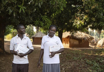 This photo provided by World Relief shows care group volunteers Neimate Mustafa and John Simon Mbiliwele, who provide community health education, visiting a homestead in January 2022, in Maridi, South Sudan. (Esther Mbabazi/World Relief via AP)