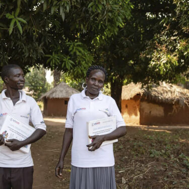 This photo provided by World Relief shows care group volunteers Neimate Mustafa and John Simon Mbiliwele, who provide community health education, visiting a homestead in January 2022, in Maridi, South Sudan. (Esther Mbabazi/World Relief via AP)