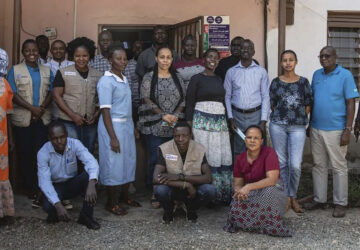 This photo provided by World Relief shows World Relief staff in front of their office in January 2022, in Juba, South Sudan. (Esther Mbabazi/World Relief via AP)