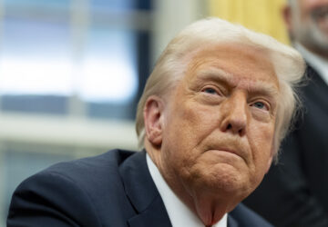 FILE - President Donald Trump speaks with reporters as he signs executive orders in the Oval Office at the White House, Monday, Feb. 10, 2025, in Washington. (AP Photo/Alex Brandon, file)