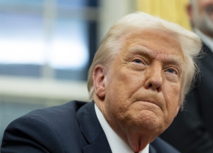 FILE - President Donald Trump speaks with reporters as he signs executive orders in the Oval Office at the White House, Monday, Feb. 10, 2025, in Washington. (AP Photo/Alex Brandon, file)