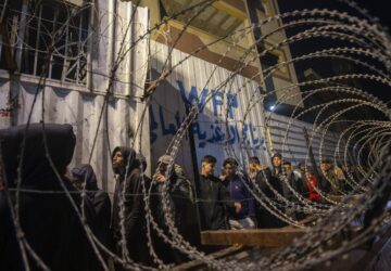 FILE - Palestinians wait in line at a World Food Program (WFP) distribution center in Gaza City's Jabalya refugee camp, Thursday, Feb. 6, 2025. (AP Photo/Jehad Alshrafi, file)