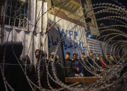 FILE - Palestinians wait in line at a World Food Program (WFP) distribution center in Gaza City's Jabalya refugee camp, Thursday, Feb. 6, 2025. (AP Photo/Jehad Alshrafi, file)