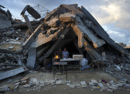 FILE - A man sells bread under the ruin of his bakery destroyed by the Israeli air and ground offensive in Jabaliya, Gaza Strip, Wednesday, Feb. 5, 2025. (AP Photo/Abdel Kareem Hana, file)