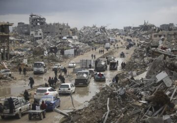 FILE - Cars and pedestrians move along a road amid widespread destruction caused by the Israeli military's ground and air offensive against Hamas in Gaza City's Jabaliya refugee camp, Friday, Feb. 7, 2025. (AP Photo/Jehad Alshrafi, file)