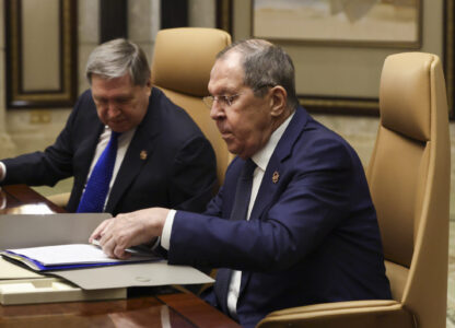 Russian Foreign Minister Sergei Lavrov, right, sits next to Russian President Vladimir Putin's foreign policy advisor Yuri Ushakov during a meeting with U.S. Secretary of State Marco Rubio, U.S. National Security Advisor Mike Waltz and U.S. Middle East envoy Steve Witkoff, Saudi Foreign Minister Prince Faisal bin Farhan Al Saud and Saudi National Security Advisor Mosaad bin Mohammad Al-Aiban, at Diriyah Palace, in Riyadh, Saudi Arabia, Tuesday, Feb. 18, 2025. (Evelyn Hockstein/Pool Photo via AP)